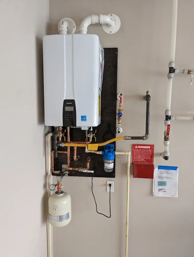 Professional plumber installing copper piping in a Luling home